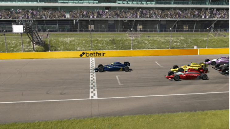 virtual motor race underway on a racing circuit with betfair banner in background