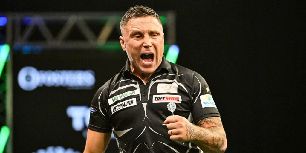 Gerwyn Price celebrating on stage playing darts