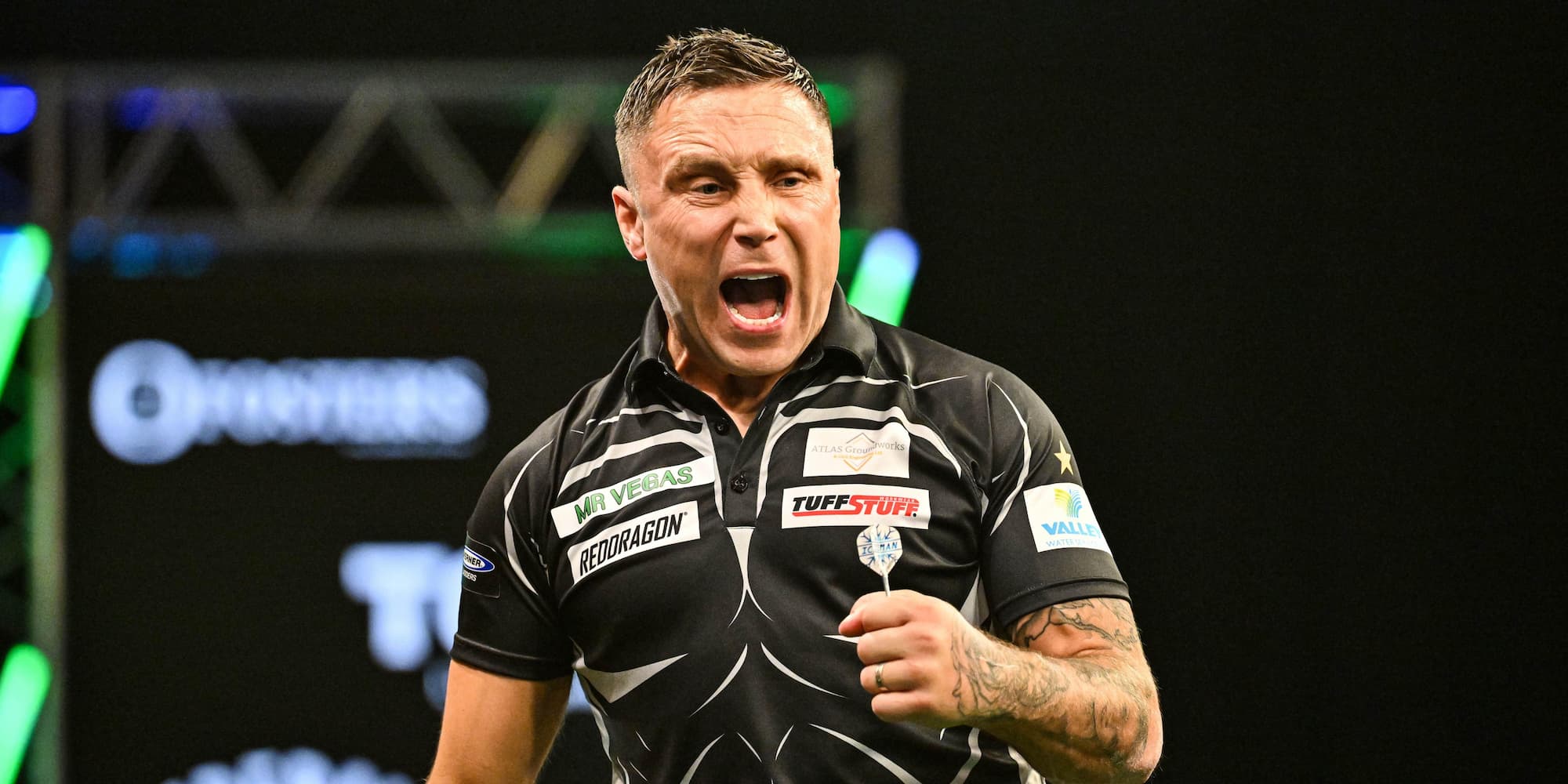 Gerwyn Price celebrating on stage playing darts