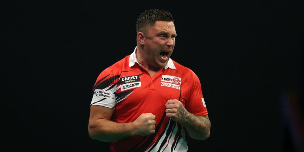 Gerwyn Price celebrates on stage in the Premier League