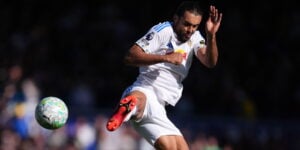 Dominic Calvert-Lewin jumping to kick a football for Leeds United