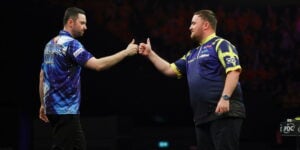 Luke Humphries and Luke Littler fist bump each other on stage in the Darts Premier League