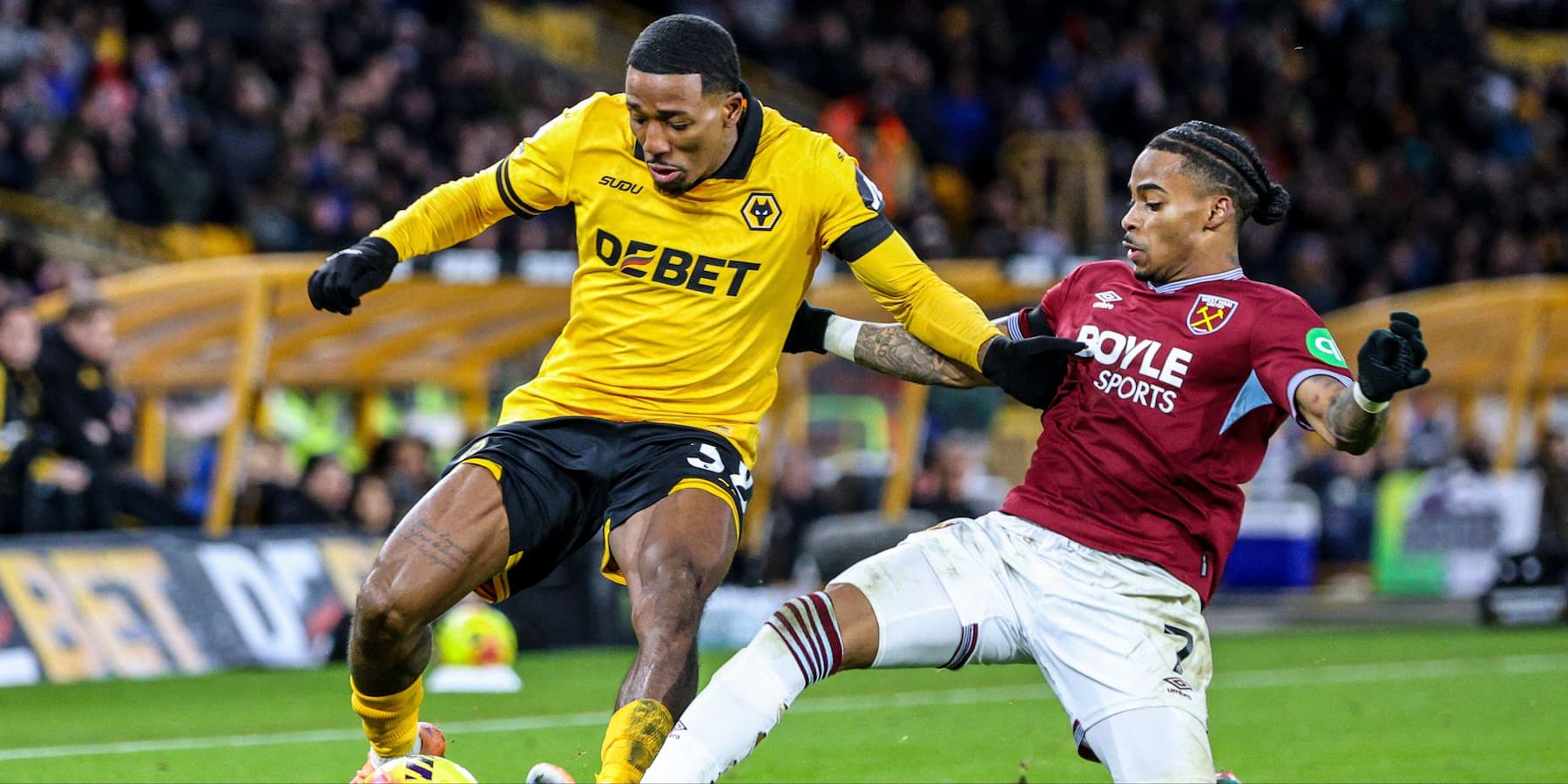 Crysencio Summerville (7 West Ham) tackles Jackson Tchatchoua (38 Wolves) during the Premier League football match between Wolverhampton Wanderers and West Ham United
