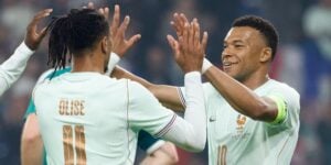 Michael Olise and Kylian Mbappe celebrate after scoring against Northern Ireland