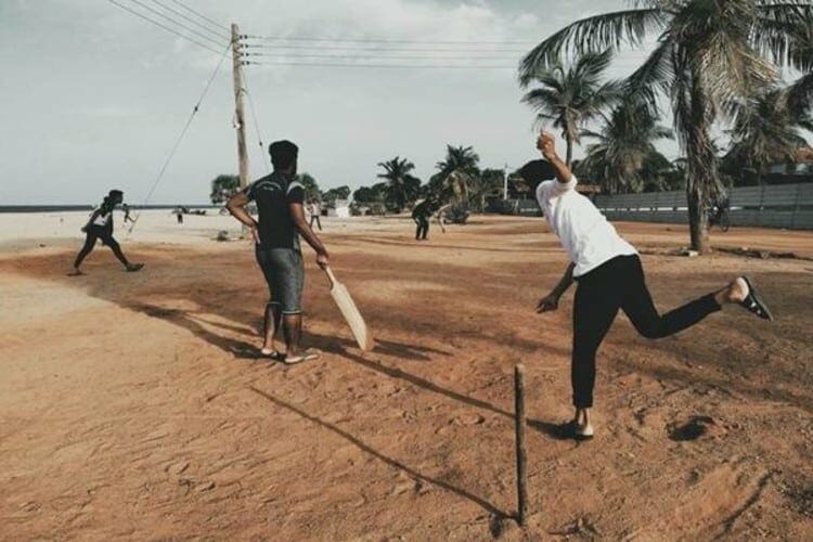 Swoosh! – Two Teams are Playing Cricket at a Beach.
